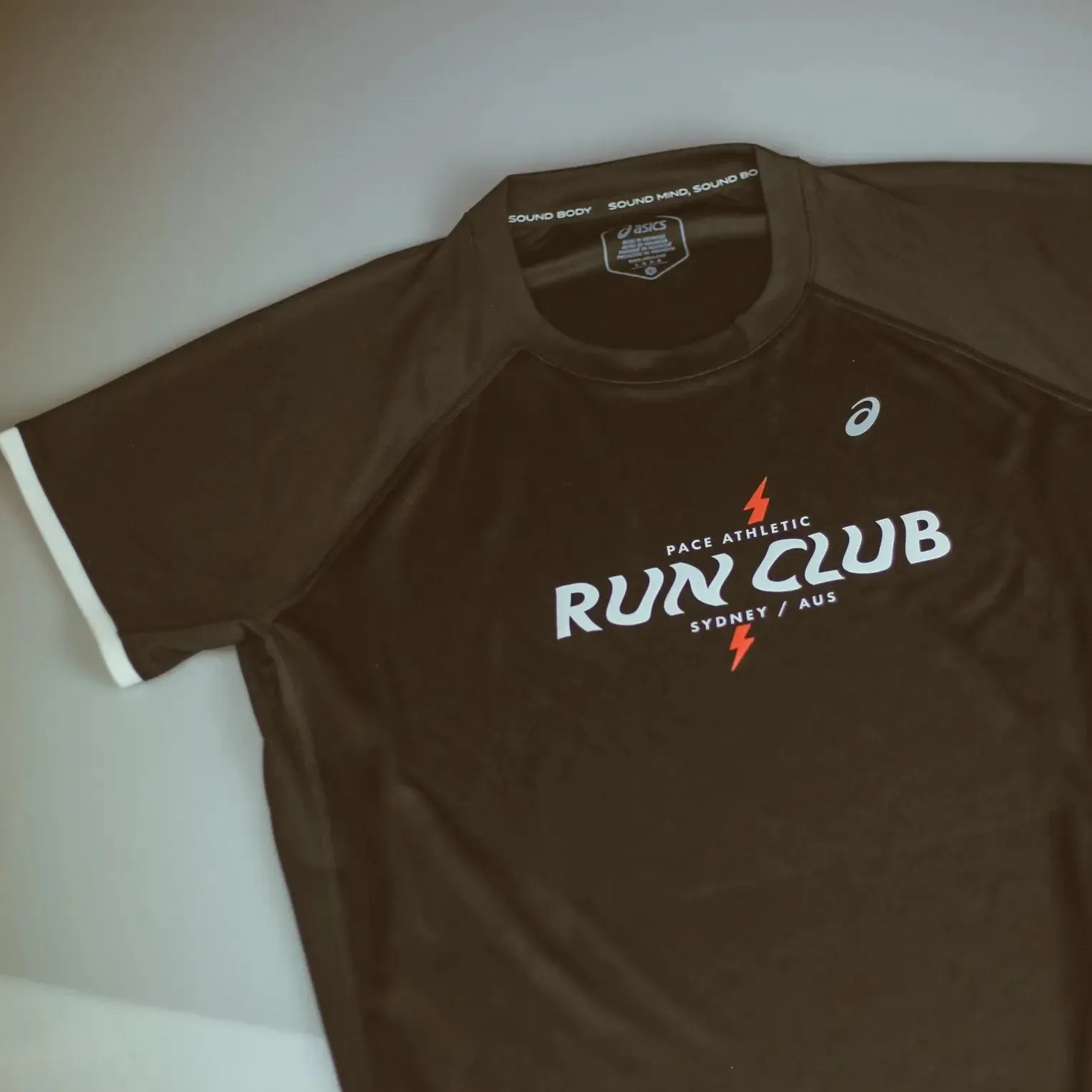 Womens ASICS x Run Club Icon Short Sleeve Top - Performance Black AdjustableCuffs Red Flash